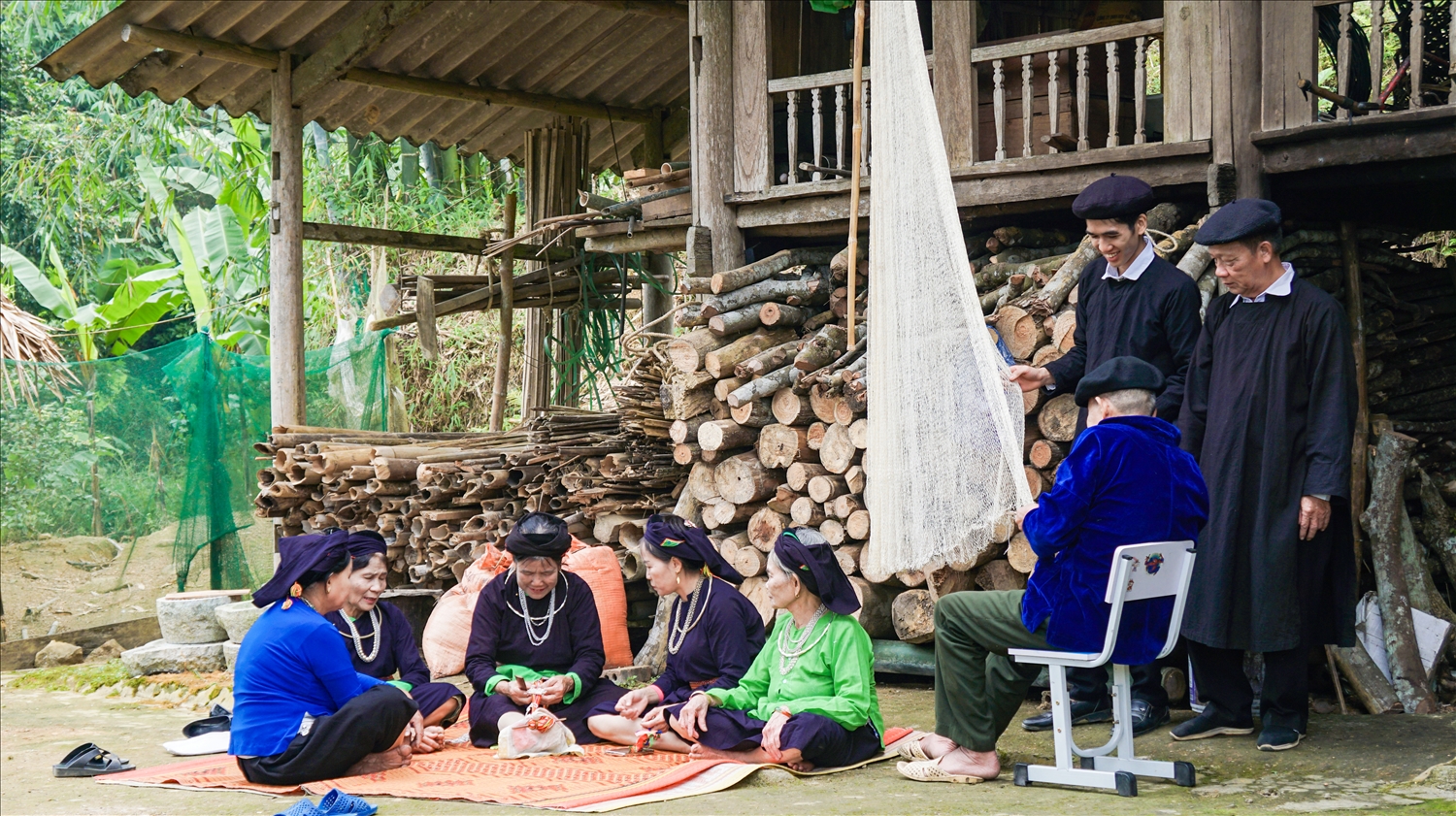 Em Hoàng Xuân Tuyền (người đứng bên trái) học hỏi từ những nghệ nhân trong xã về nghề truyền thống của dân tộc Tày.