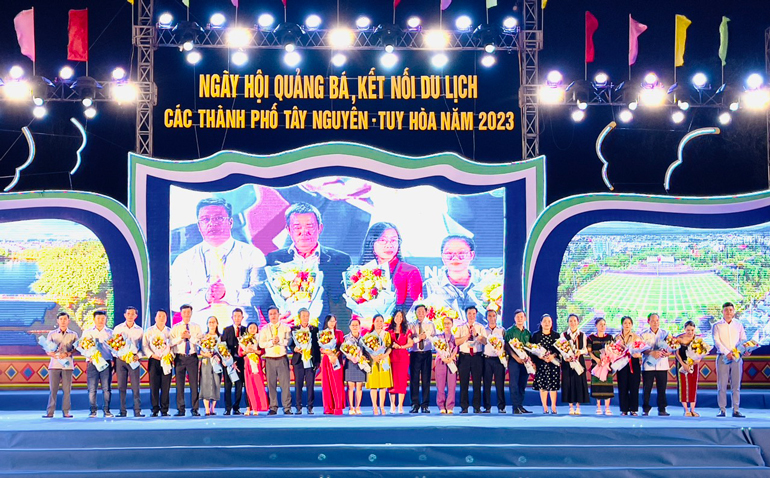 Lãnh đạo TP Tuy Hoà và TP Pleiku tặng hoa cảm ơn các đơn vị tham gia giới thiệu sản phẩm du lịch, OCOP trong chương trình ngày hội. Ảnh- TRẦN QUỚI
